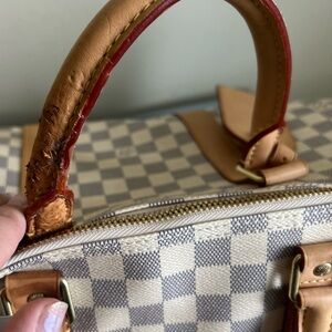 Louis Vuitton duffle bag, two of the straps are damaged as shown in pictures.